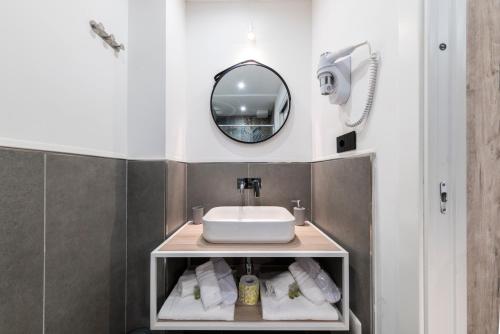 a bathroom with a sink and a mirror at NG Guest House il Gallura in Olbia