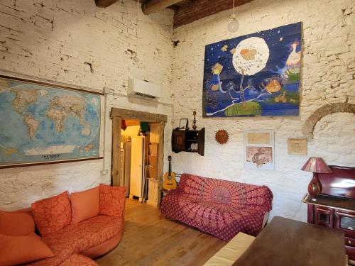 a living room with a couch and a map on the wall at Tertulia Coliving Coworking in Ampinana