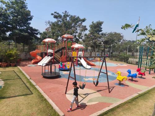 a child is playing in a playground at Spacious 3 BHK inHigher flr with Sunset, Lake View in Bengaluru