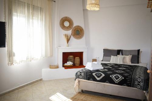 a bedroom with a bed and a fireplace at Selanna Luxury Apartments in Skiathos Town