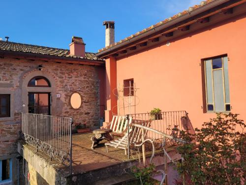 a balcony of a house with a bench on it at Tertulia Coliving Coworking in Ampinana