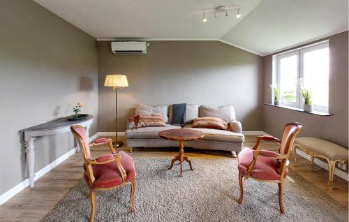a living room with a couch and a table and chairs at 2 Bedroom Beautiful Home In Fleninge - S12280 in Fleninge