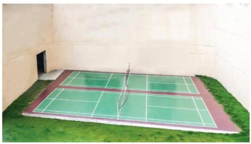 a tennis court with a net in a room at Spacious 3 BHK inHigher flr with Sunset, Lake View in Bengaluru