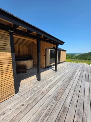 a wooden deck with a pavilion on aestead at Polana Jelenia Głowa in Wambierzyce