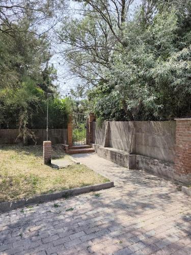 a brick fence with a gate in a yard at Casa di Vira in Calambrone