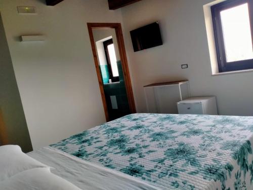 a bedroom with a bed and a window at Contrada Cafaro in Salerno