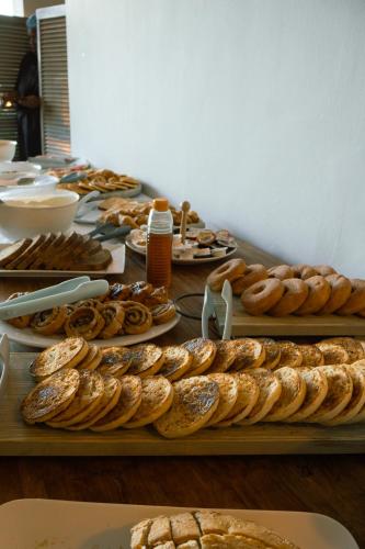 a table topped with lots of different types of bread at Ocean Breeze Hotel in Strand