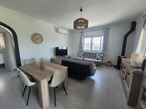 a living room with a table and a couch at Villa Kiki in Morche
