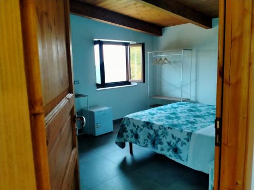 a small room with a bed and a window at Contrada Cafaro in Salerno