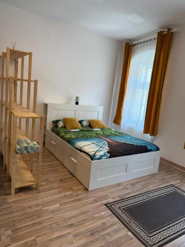 a bedroom with a bed and a window and a ladder at Vadim's guesthouse in Sibiu