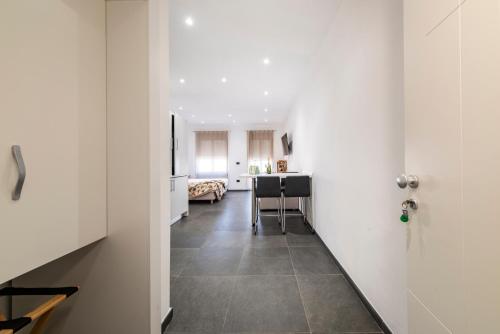 a hallway with a kitchen and a dining room at NG Guest House il Gallura in Olbia