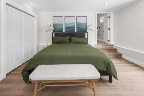 a bedroom with a large green bed with a bench at Secluded Cabin w/ Hot tub near French Lick, IN in French Lick