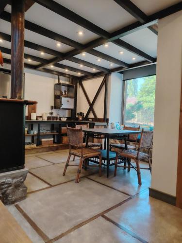 a dining room with a table and chairs at Casas Viejas de Rauco, casa patrimonial en el campo in Curicó