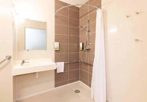 a bathroom with a sink and a shower at B&B HOTEL Saint Jean de Luz in Saint-Jean-de-Luz