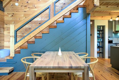 a wooden table and chairs in a room with a blue wall at Adventure of a Lifetime by Carolina Mornings in Saluda