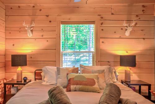 a bedroom with wooden walls and a bed with two lamps at Adventure of a Lifetime by Carolina Mornings in Saluda