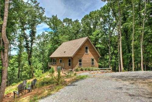 a log cabin in the woods with a gravel road at Adventure of a Lifetime by Carolina Mornings in Saluda
