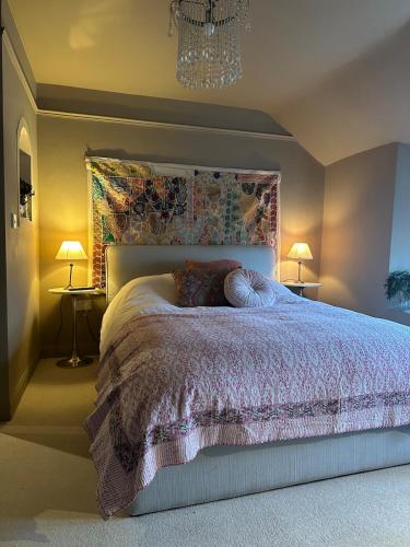 a bedroom with a bed and two lamps and a chandelier at Flat in Woodstock in Woodstock