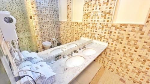 a bathroom with two sinks and a mirror at Cozy House in Rio de Janeiro