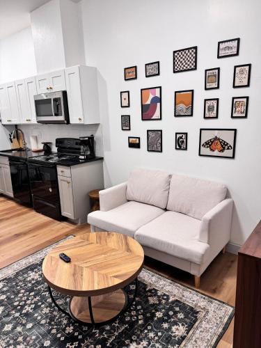 a living room with a white couch and a coffee table at Cozy Stay Near Fishtown - Close to Subway & Center City by Globenest in Philadelphia
