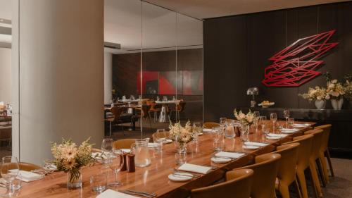 a long dining room with a long table and chairs at InterContinental Brisbane by IHG in Brisbane