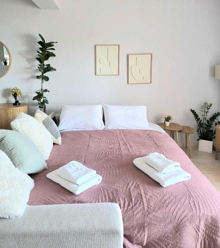 a large bed with two towels on top of it at Ionelia Seaview Apartment at Barbati in Barbati