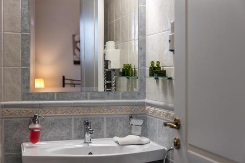 a bathroom with a sink and a mirror at Ostria Hotel  in Adamas