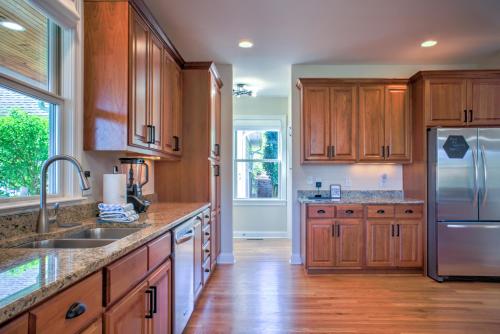 a kitchen with wooden cabinets and a stainless steel refrigerator at Dos Brisas by Carolina Mornings in Mars Hill