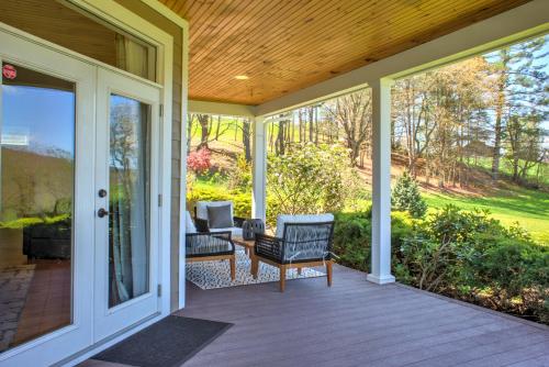 a screened in porch with a chair and a couch at Dos Brisas by Carolina Mornings in Mars Hill
