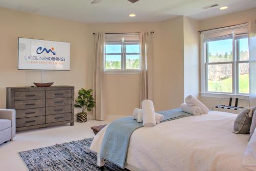 a bedroom with a large bed and a dresser at Dos Brisas by Carolina Mornings in Mars Hill