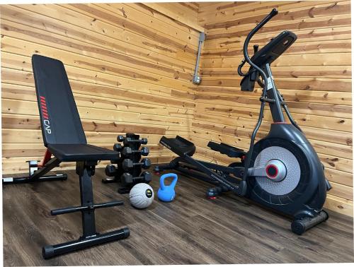 a gym with a treadmill and a exercise bike at Dos Brisas by Carolina Mornings in Mars Hill
