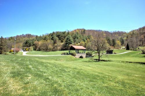 a grassy field with a gazebo in the distance at Dos Brisas by Carolina Mornings in Mars Hill
