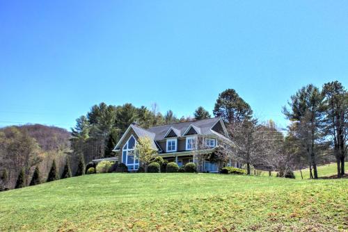 a house on a hill with a green lawn at Dos Brisas by Carolina Mornings in Mars Hill