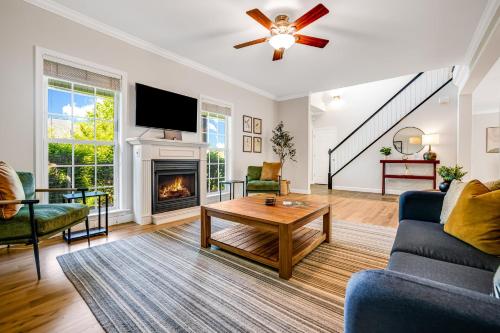 a living room with a fireplace and a tv at Lauren Peak by Carolina Mornings in Candler