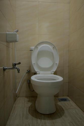 a bathroom with a toilet with the lid up at Msovi House in Arusha