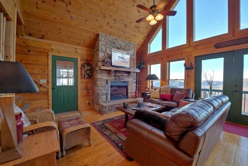 a living room with a couch and a fireplace at Sky High by Carolina Mornings in Swiss