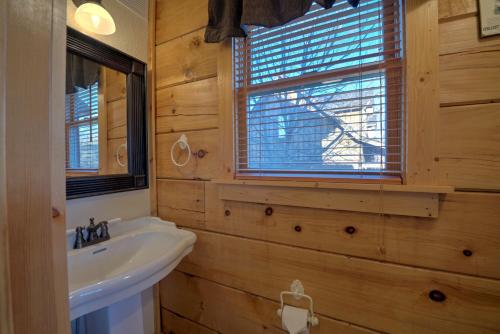 a bathroom with a sink and a mirror and a window at Sky High by Carolina Mornings in Swiss