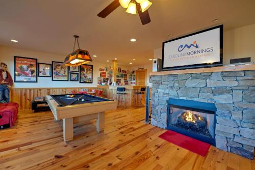 a living room with a pool table and a fireplace at Sky High by Carolina Mornings in Swiss