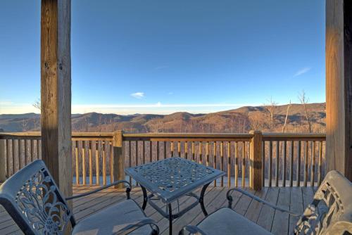 a patio with a table and chairs on a deck at Sky High by Carolina Mornings in Swiss