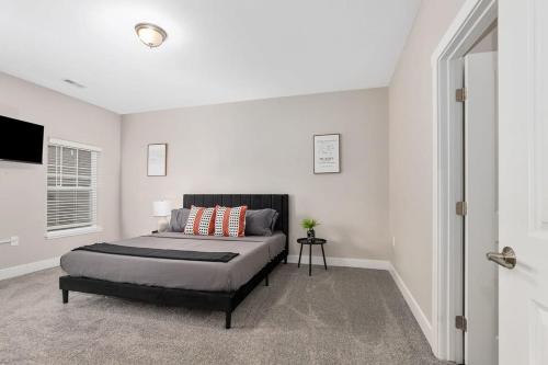 a bedroom with a large bed in a white room at Modern 16BR 16BA Condos w Garage and Patio in Wyoming