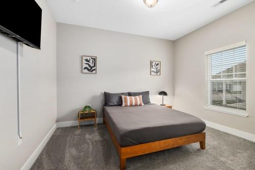 a bedroom with a bed and a flat screen tv at Modern 16BR 16BA Condos w Garage and Patio in Wyoming