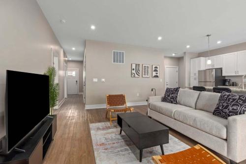 a living room with a couch and a flat screen tv at Modern 16BR 16BA Condos w Garage and Patio in Wyoming