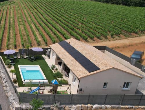 an aerial view of a house with solar panels on it at En Ardèche Villa de vacances l'Olympe climatisée avec sa piscine privée et chauffée in Joyeuse