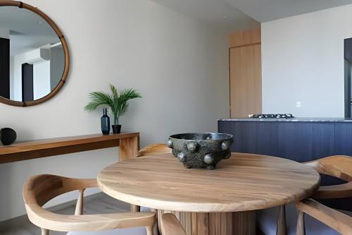 a wooden table in a kitchen with a mirror at Sao Paulo Vertical in Guadalajara