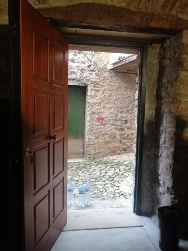 an open door in a room with a stone wall at #3MTSOPRAILCIELO '' SCuLPTuRe '' in Felitto