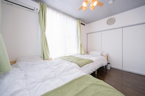 Postel nebo postele na pokoji v ubytování ひとふく塩釜