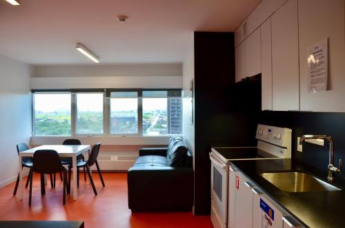 a kitchen with a table and chairs and a dining room at Tartu College Student Residence in Toronto