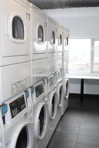 a row of washing machines in a laundry room at Tartu College Student Residence in Toronto