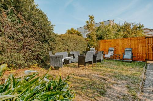 a group of chairs and tables in a yard at Open Mind Property - 4 Bedroom House with Hot Tub in Weston-super-Mare