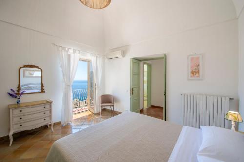 Ένα ή περισσότερα κρεβάτια σε δωμάτιο στο Casa Positamo